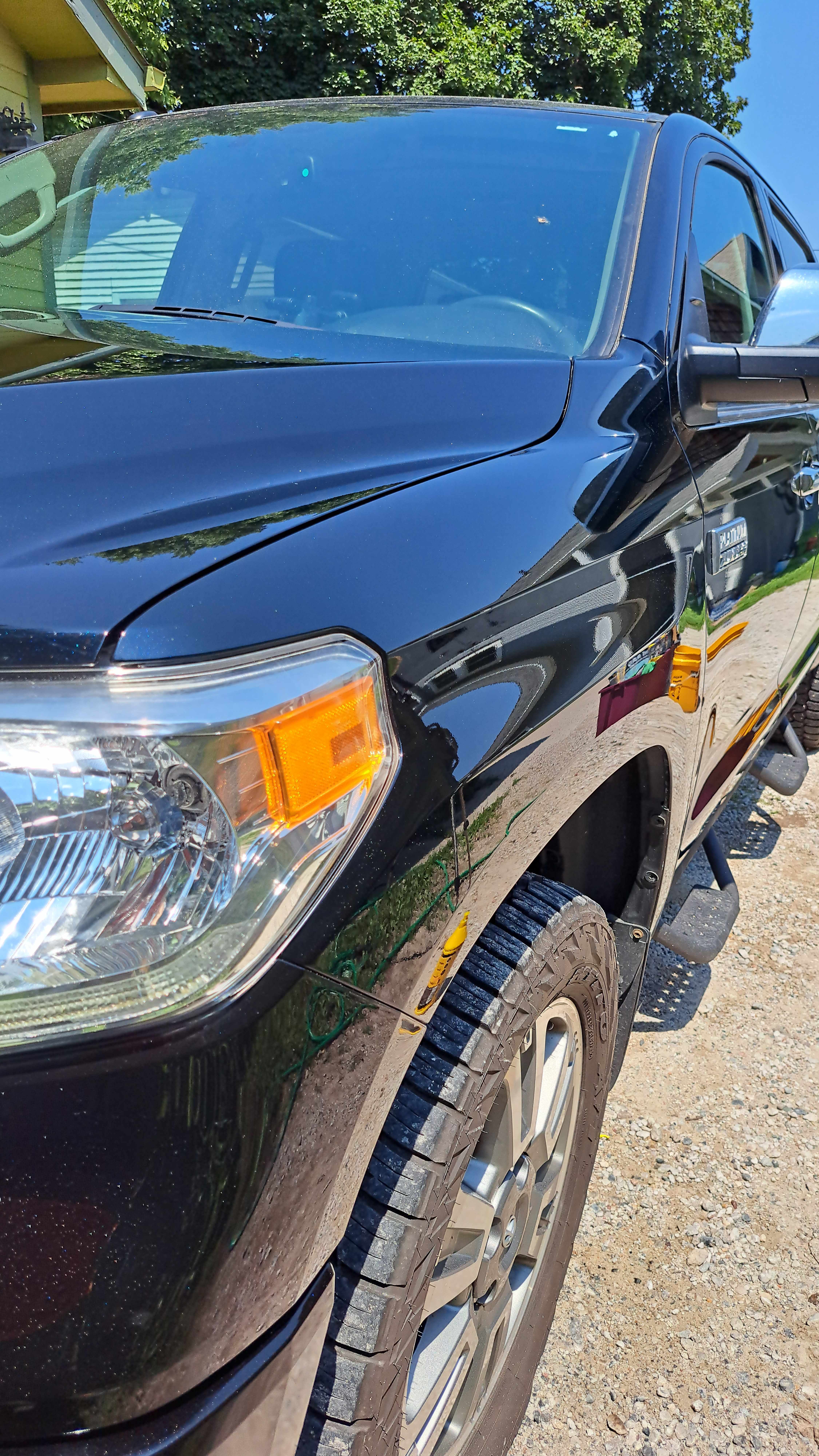 Freshly corrected black Toyota Tundra truck with a deep mirror finish after paint correction and ceramic coating, Iowa mobile detailing